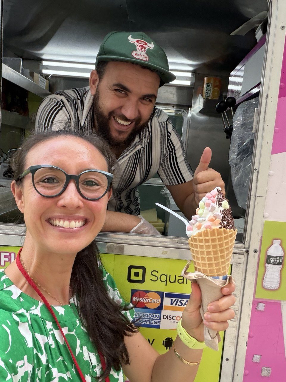 Customer taking a selfie with the 10 Flavors crew and a loaded waffle cone