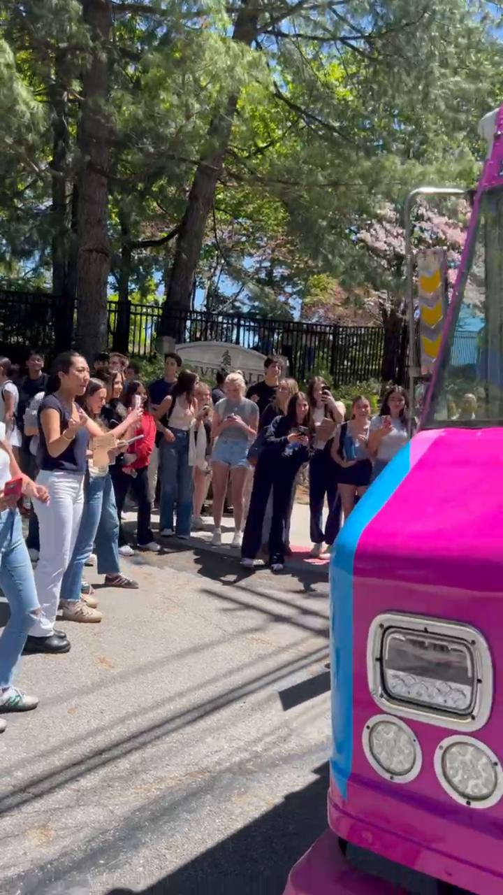 Guests lined up at a 10 Flavors ice cream truck at an outdoor event