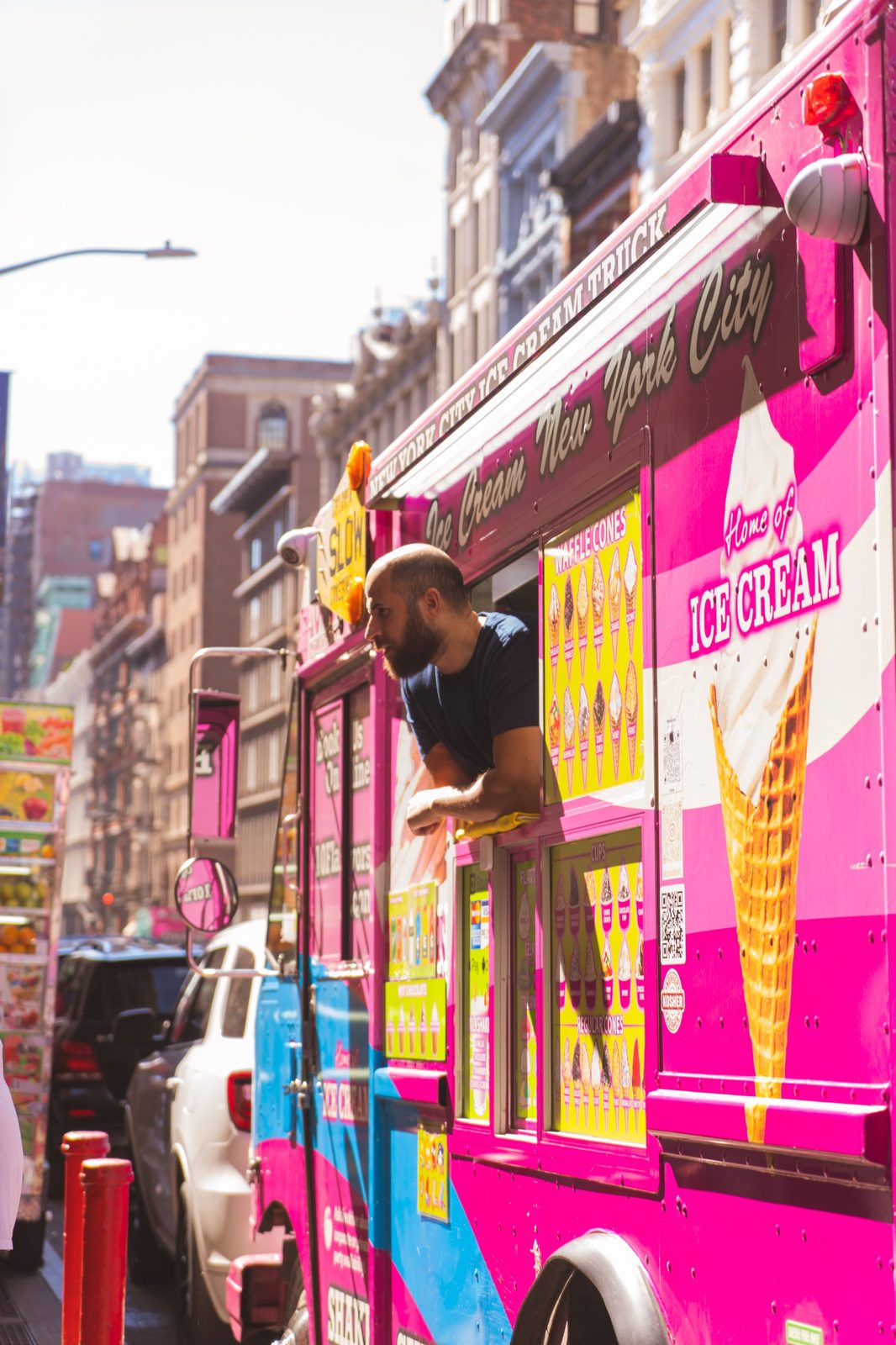 10 Flavors crew member leaning out the truck window to serve a customer on a NYC street