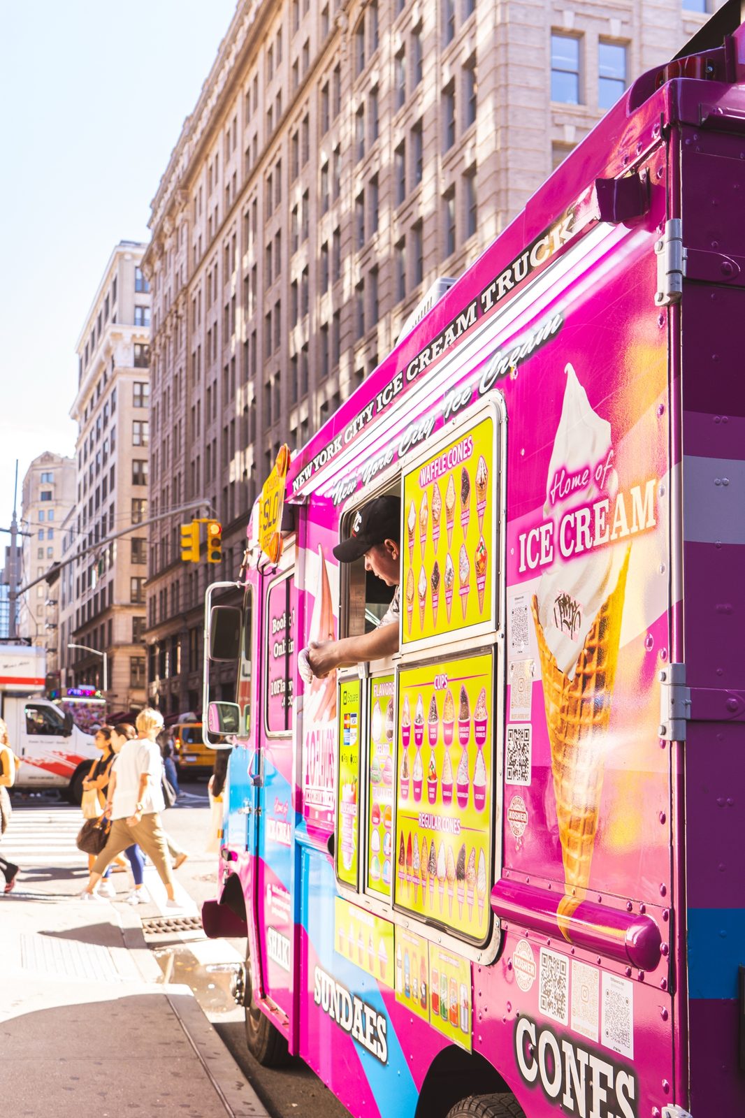 10 Flavors crew member leaning out the serving window handing a customer an ice cream