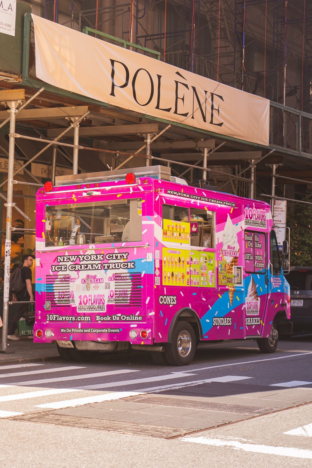 10 Flavors ice cream truck parked on a NYC street near scaffolding and a Polène storefront